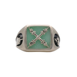 A signet ring with a square chrysoprase stone and an emblem depicting two hands on columns, with one hand's fingers crossed and the other bearing their middle finger.