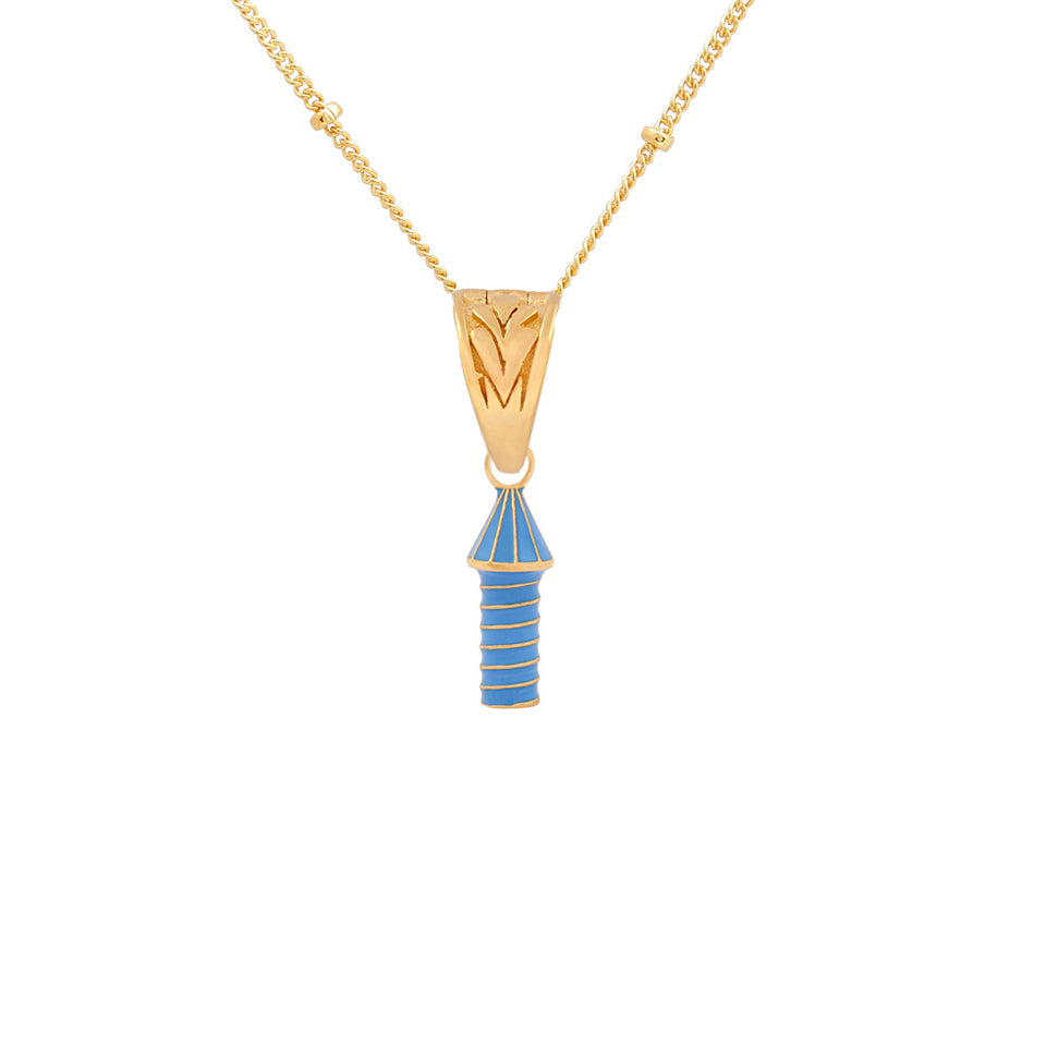 image of rocket enamel necklace with blue enamel rocket, close up view of pendant flat on white background