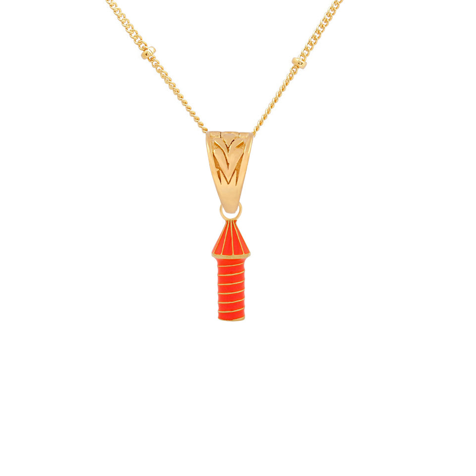image of rocket enamel necklace in orange close up of pendant on white background