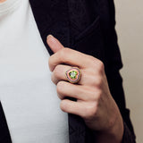 Image of firework heart ring on hand holding lapel of black jacket