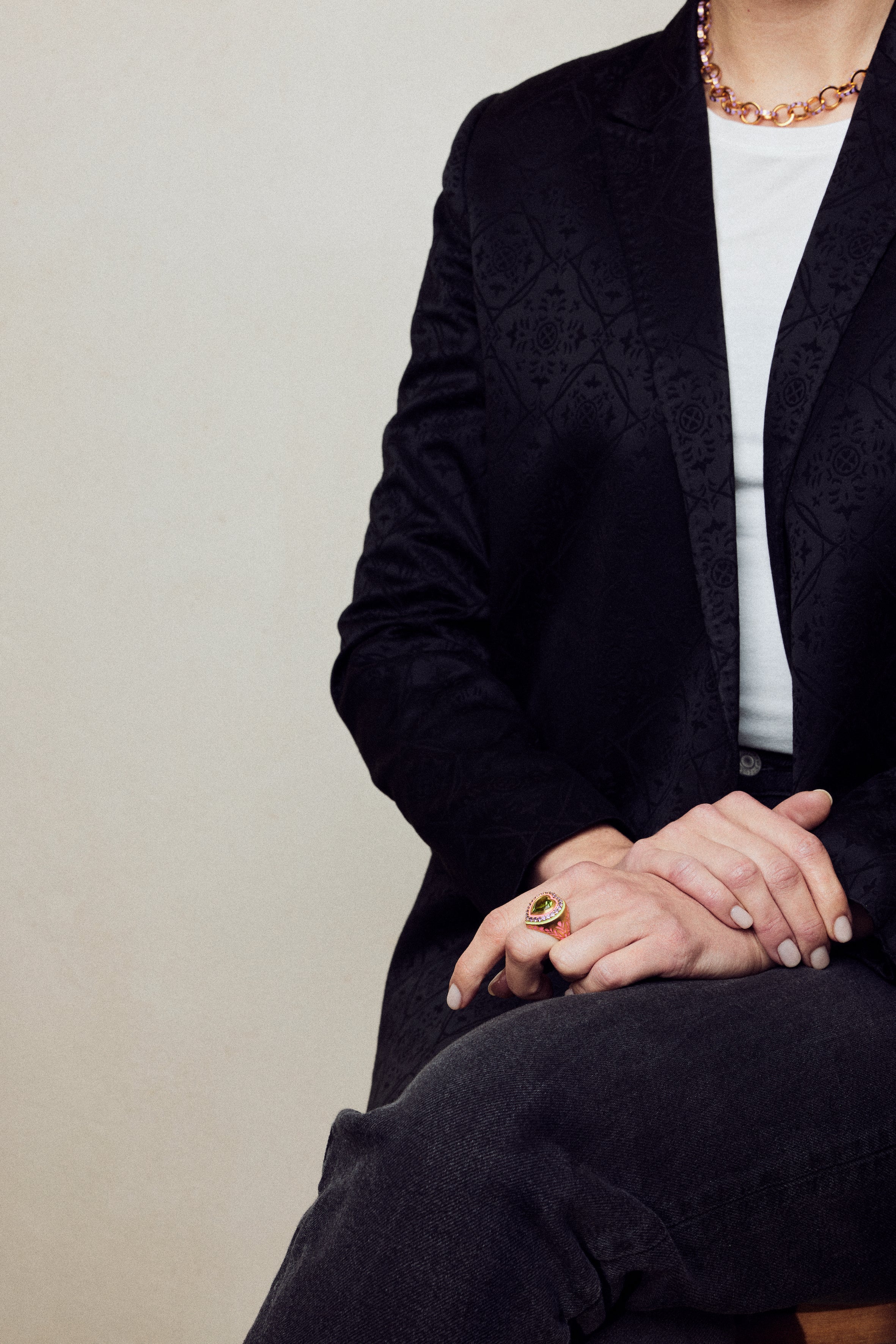 image of firework heart ring on model sitting with legs crossed and hands on lap