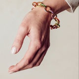 image of firework gold chain bracelet on model wrist with hand facing down
