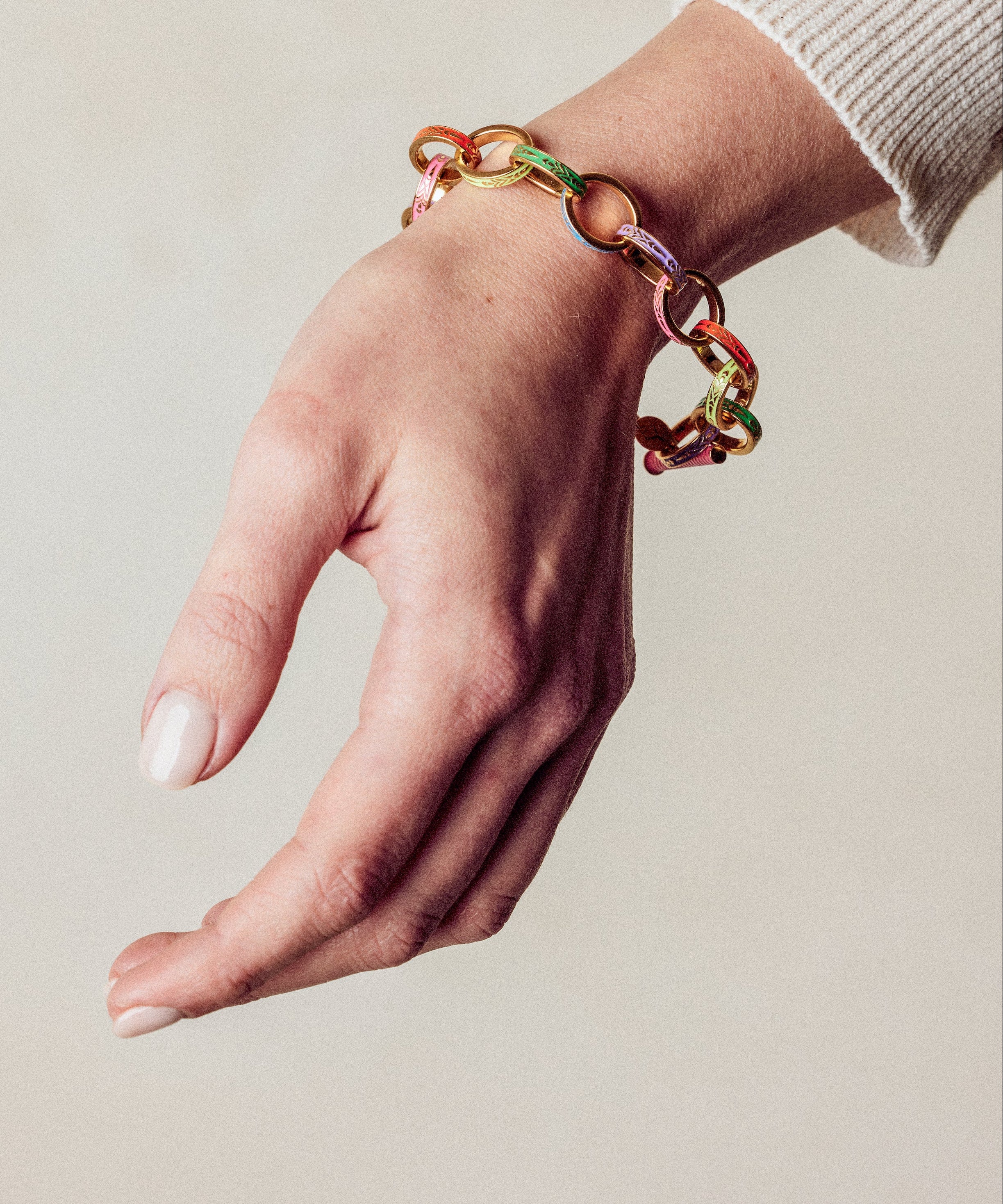 image of firework gold chain bracelet on model wrist with hand facing down