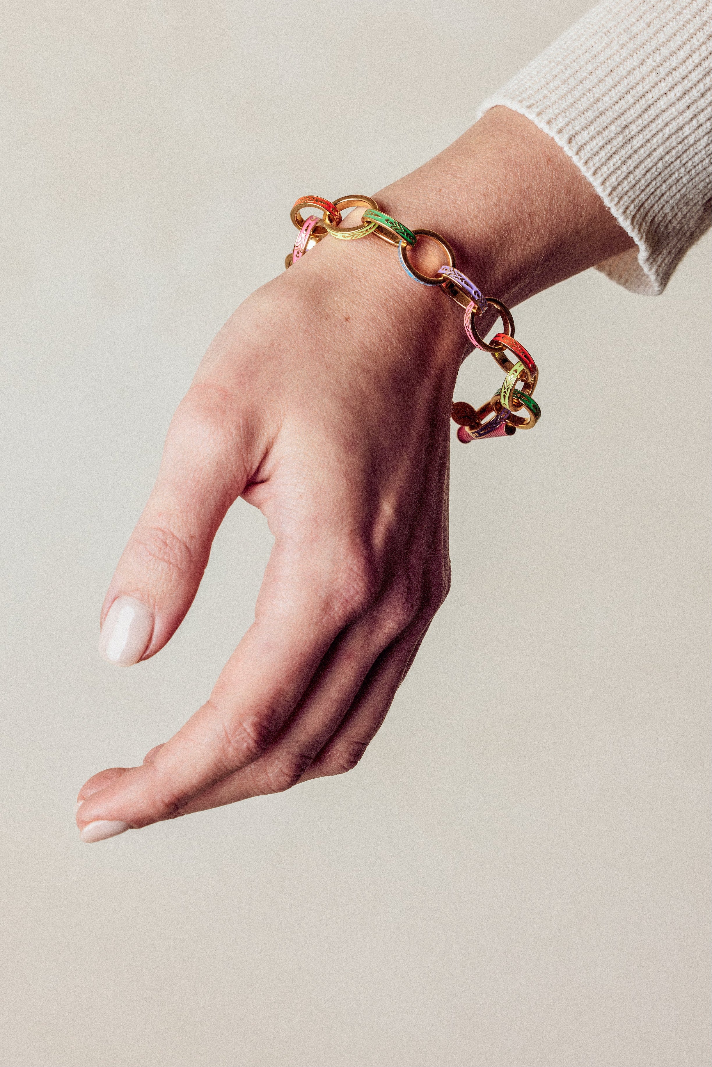 image of firework gold chain bracelet on model wrist with hand facing down