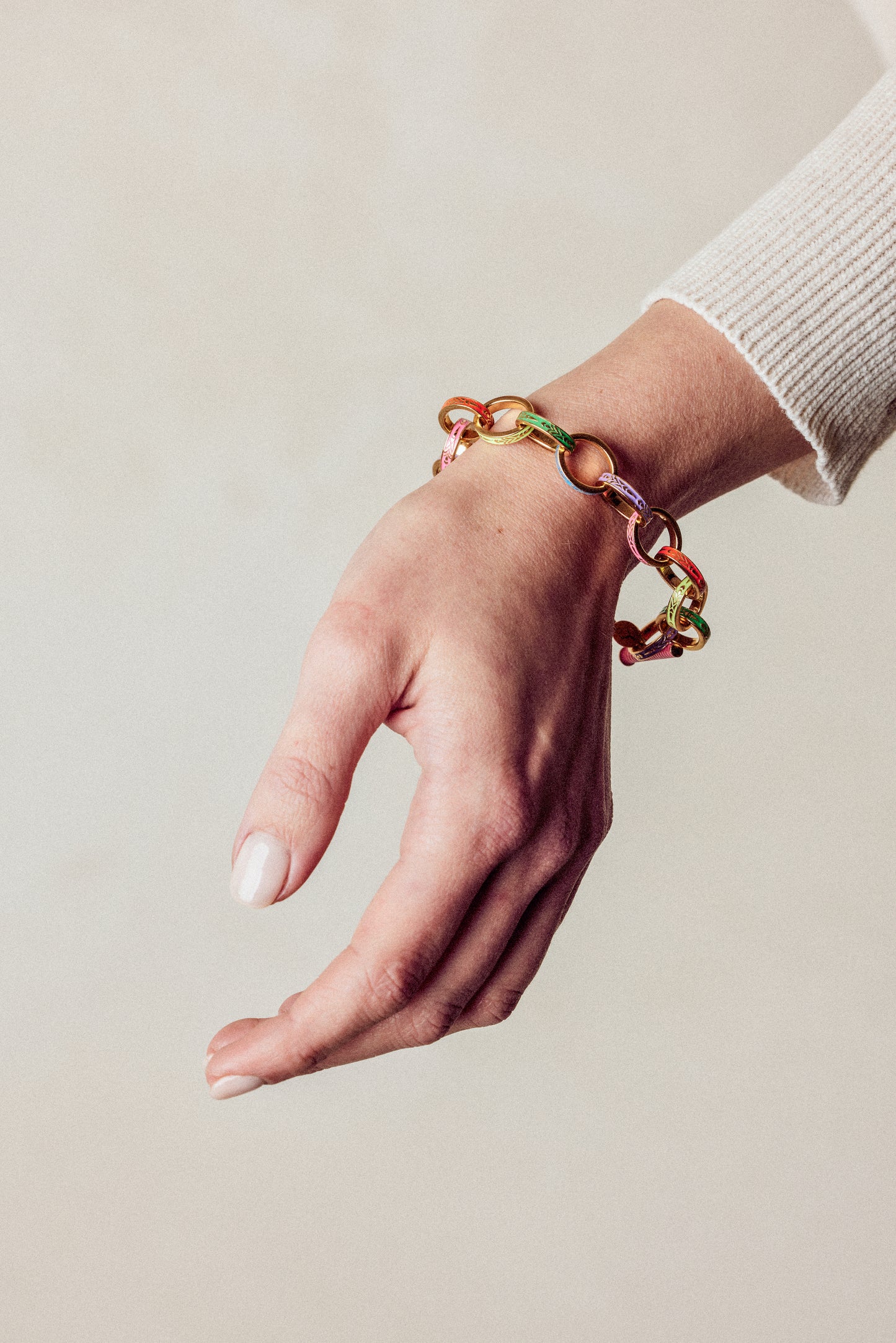 image of firework gold chain bracelet on model wrist with hand facing down