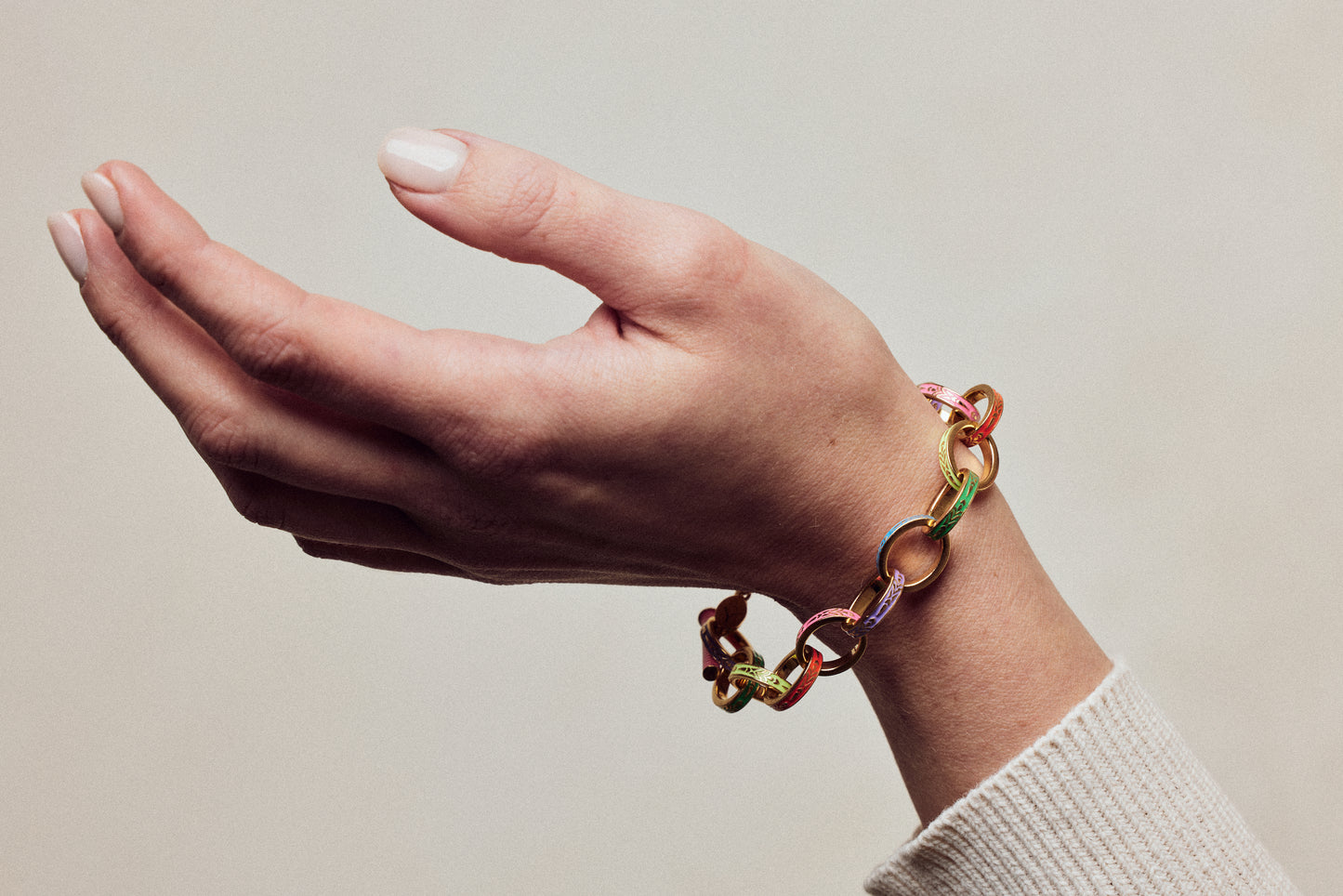 image of firework gold chain bracelet on model wrist with hand facing up