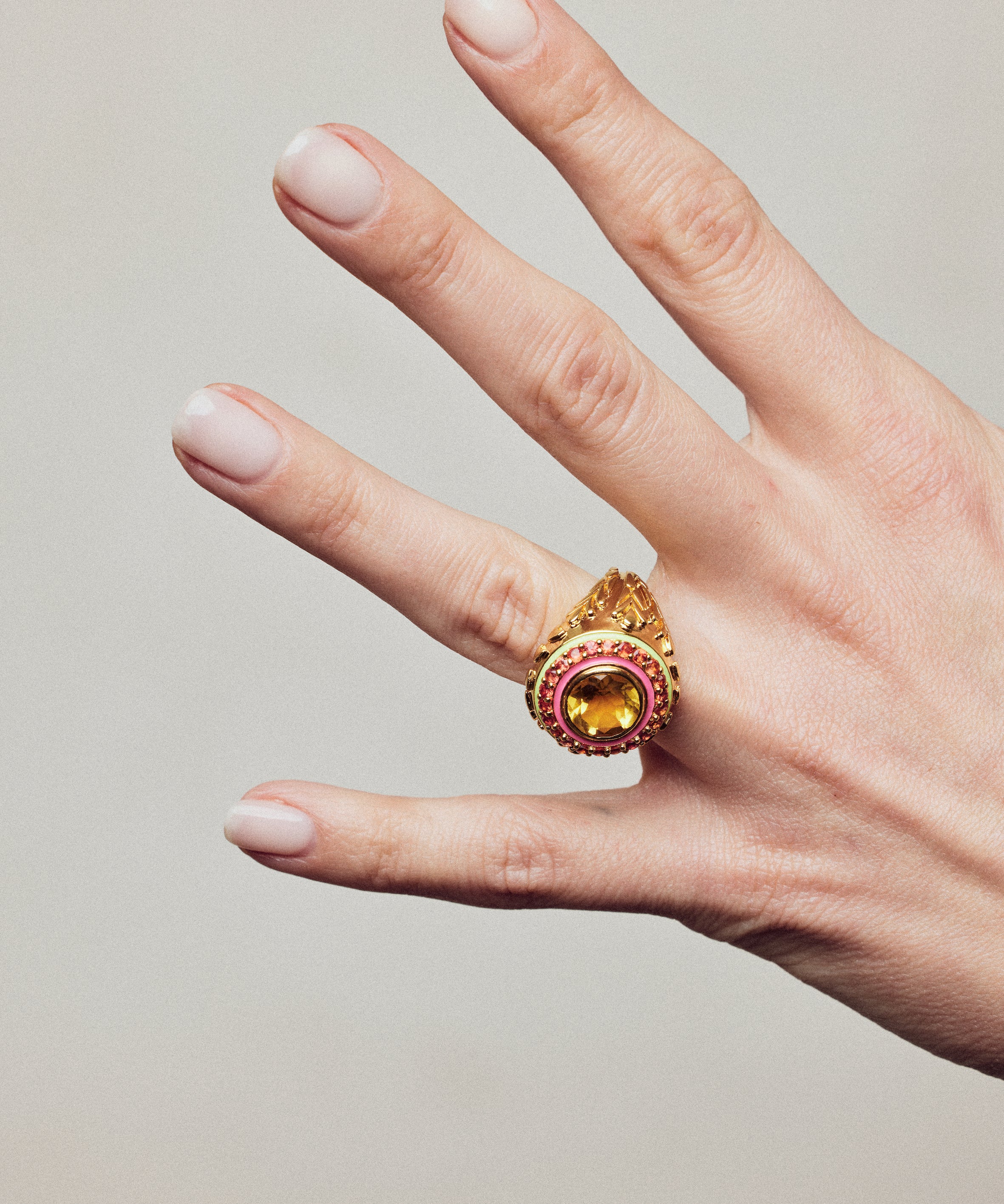 image of firework statement ring in orange and gold on hand with outstreched fingers