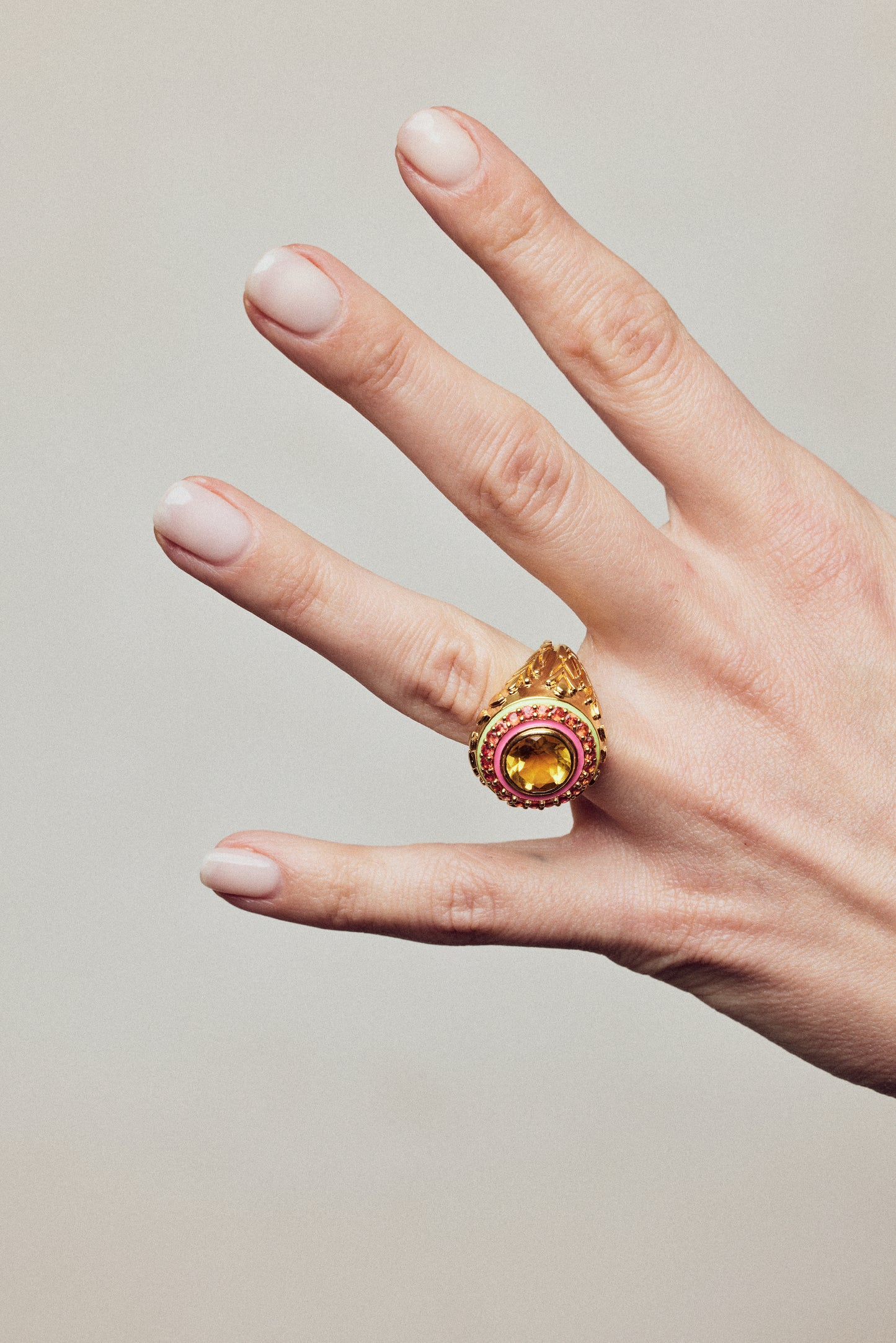 image of firework statement ring in orange and gold on hand with outstreched fingers
