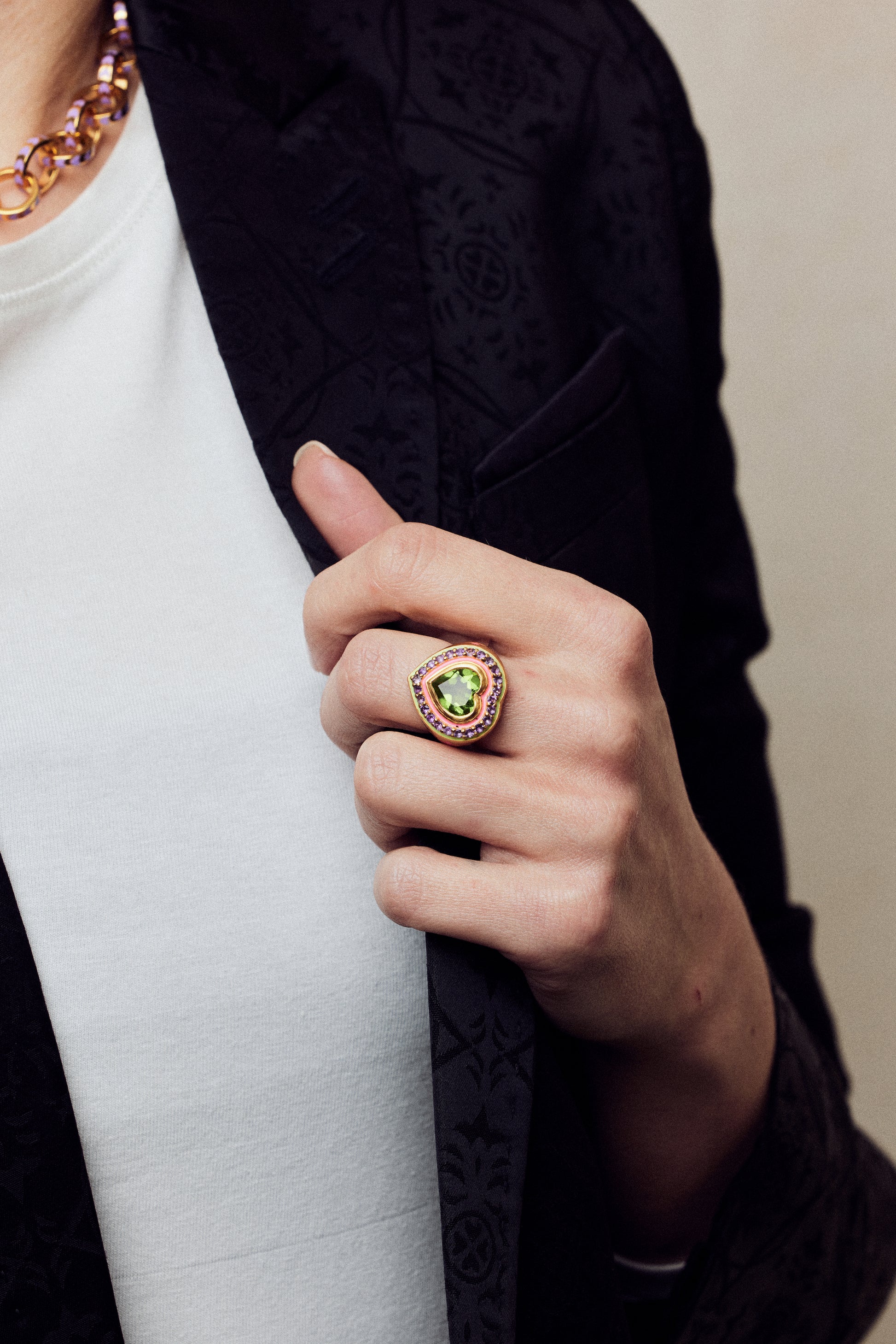 image of firework heart ring on hand holding lapel of black jacket