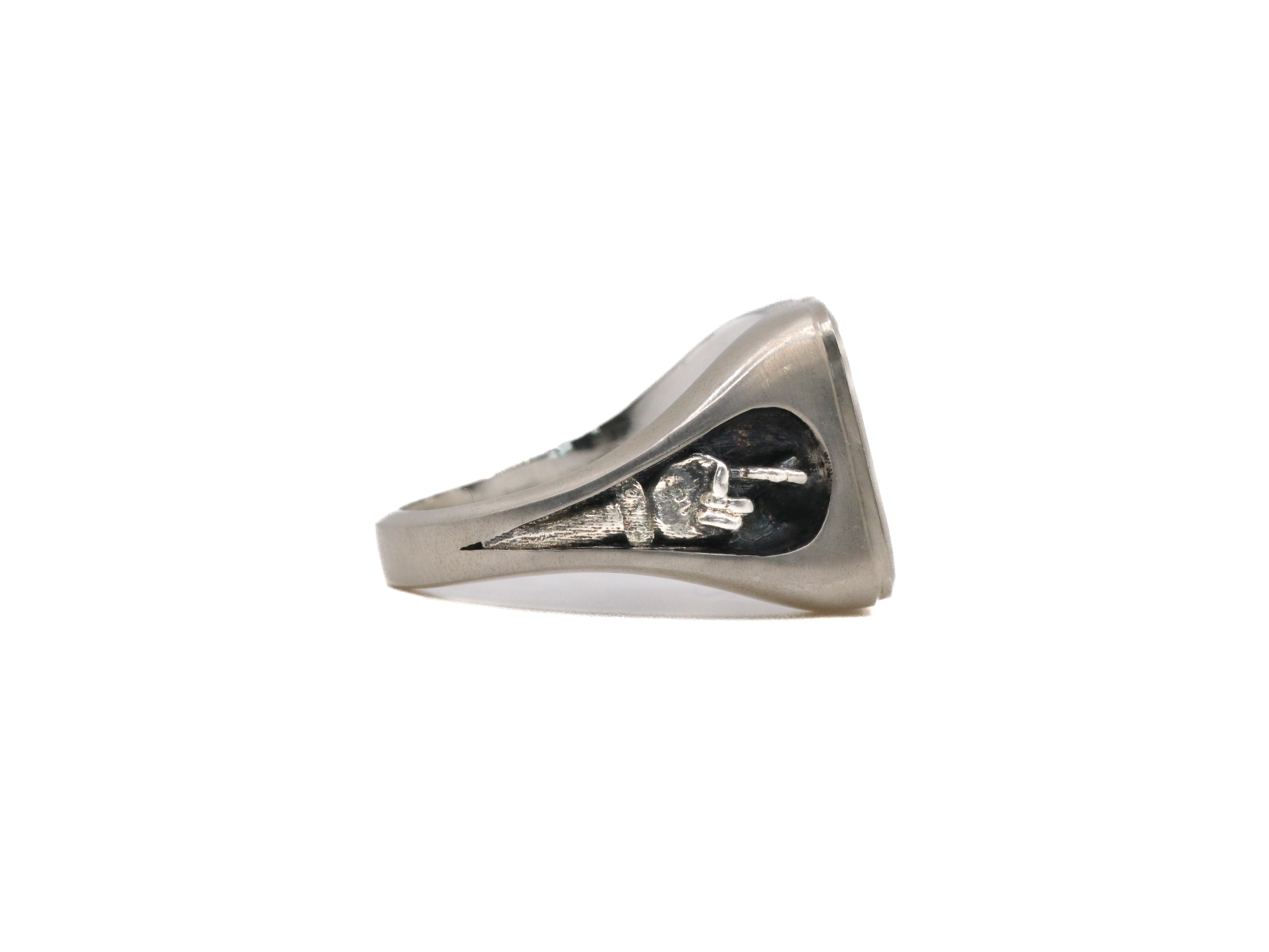 side view of stone signet ring in brushed sterling silver showing fingers crossed motif
