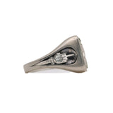 Side view of stone signet ring in brushed sterling silver showing middle finger motif