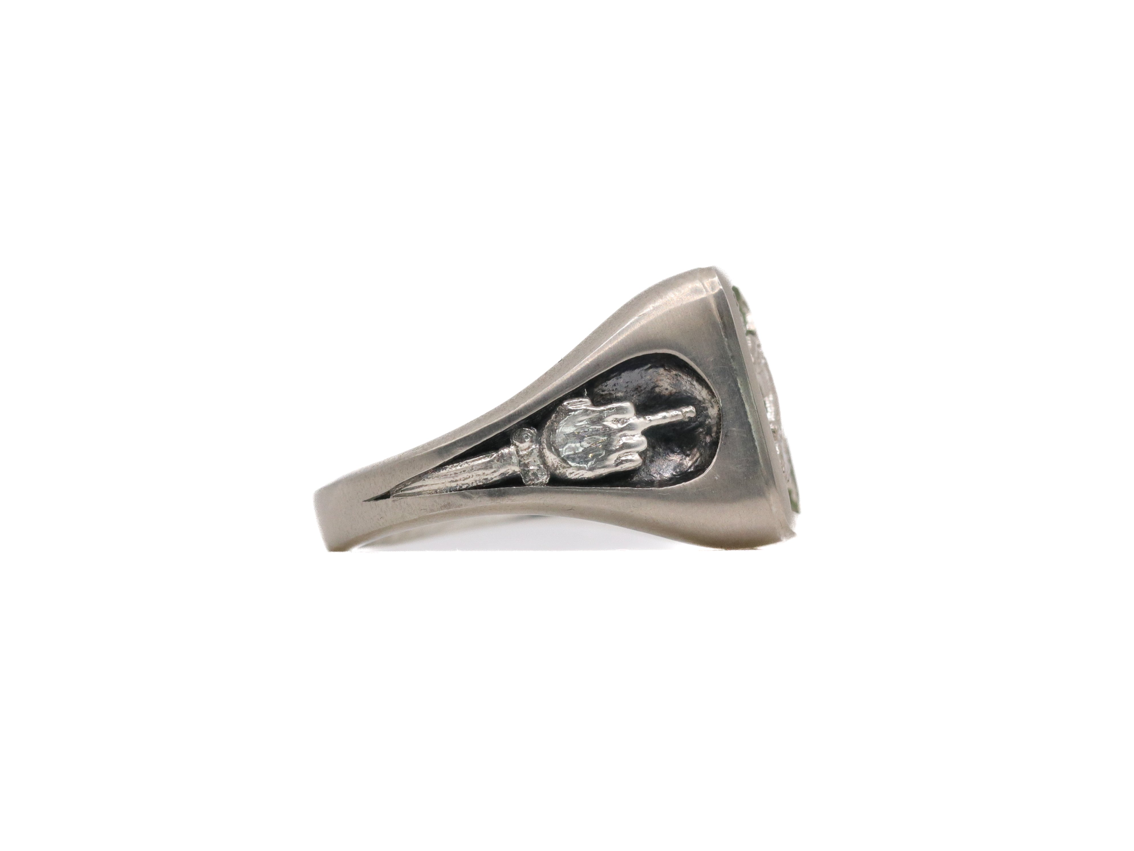 Side view of stone signet ring in brushed sterling silver showing middle finger motif