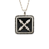 A necklace with a black onyx and natural black diamond emblem pendant on a silver chain.