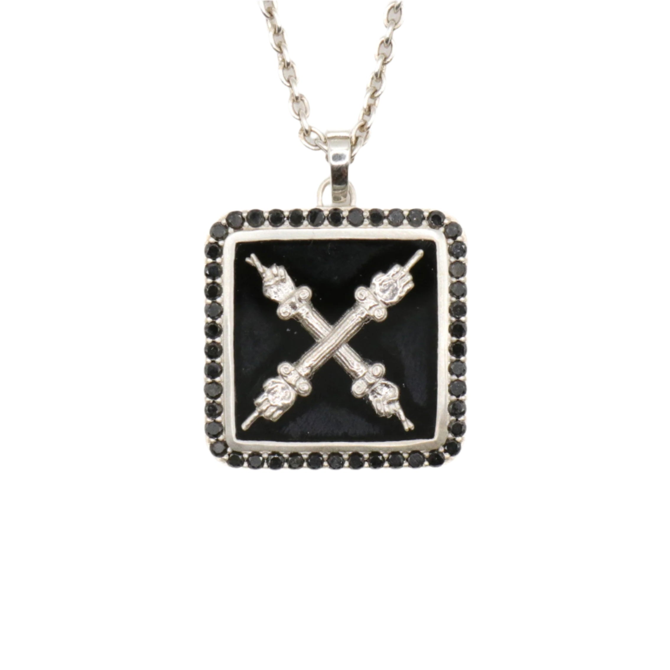 A necklace with a black onyx and natural black diamond emblem pendant on a silver chain.