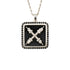 A necklace with a black onyx and natural black diamond emblem pendant on a silver chain.