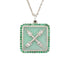 A square-shaped necklace pendant with a crest motif design, featuring chrysoprase and natural emeralds, set in recycled sterling silver, displayed on a chain.