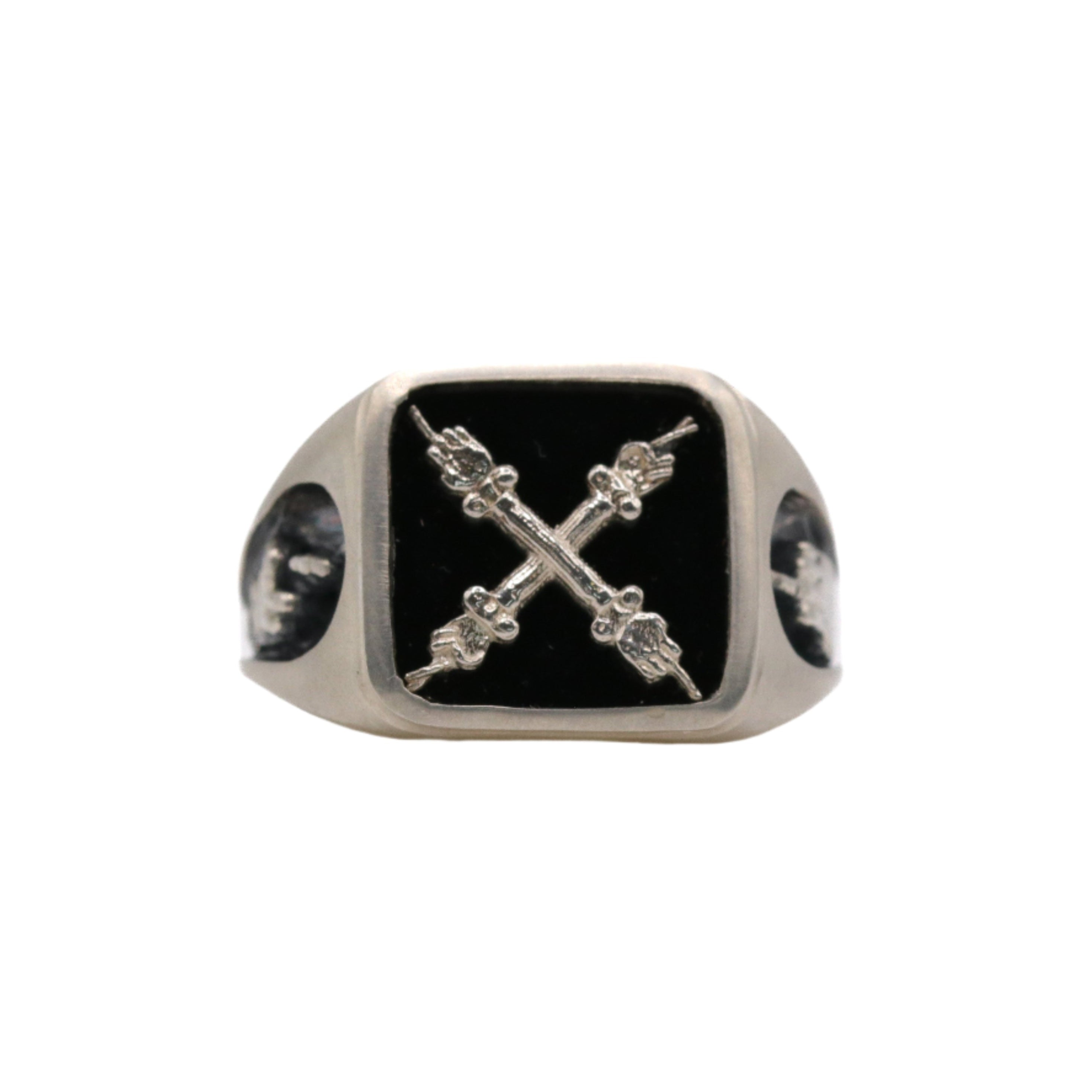 A signet ring with a black onyx emblem in recycled sterling silver, featuring a emblem depicting two hands on columns.