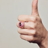 Image of statement firework ring in pink, purple and gold. On hand making thumbs up.