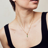 image of rocket enamel necklace on model with short brown hair in black vest top
