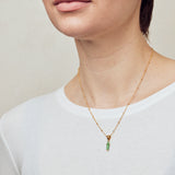 image of rocket enamel necklace on model with short brown hair wearing white top