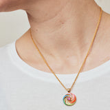 image of enamel necklace with spinning disk on short chain on model in white top close up on neck