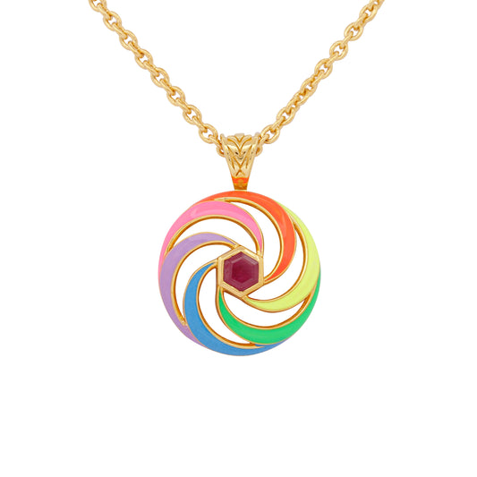 enamel necklace with spinning disk and ruby hex centre close up on white background 