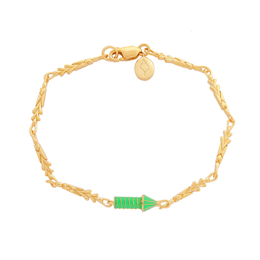 image of gold charm bracelet with green enamel rocket top down view flat on white background