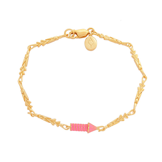 image of gold charm bracelet with pink enamel rocket top down flat view on white background