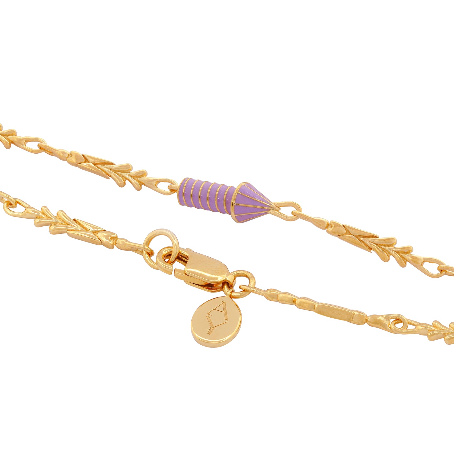 image of gold charm bracelet with purple enamel rocket close up view of rocket and lock with logo tag on white background