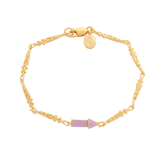 image of gold charm bracelet with purple enamel rocket flat top down view on white background