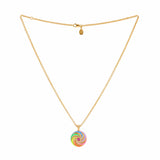 image of enamel necklace with spinning disk and ruby hex centre full length including chain on white background 